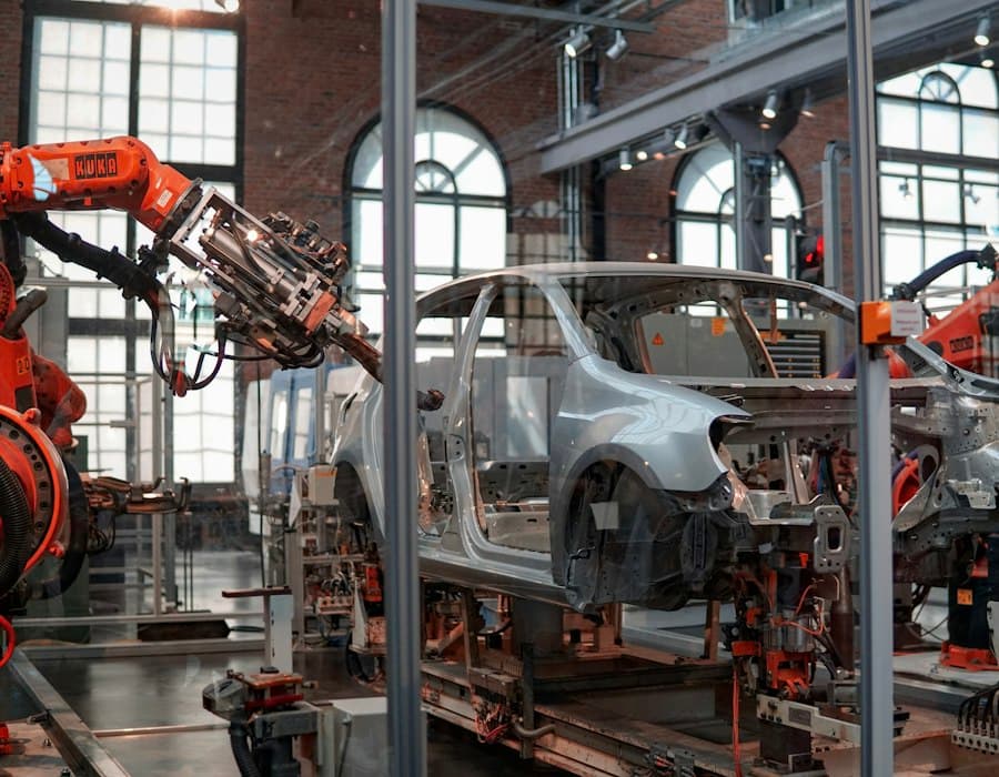 Industrial robots working on a car body on the assembly line