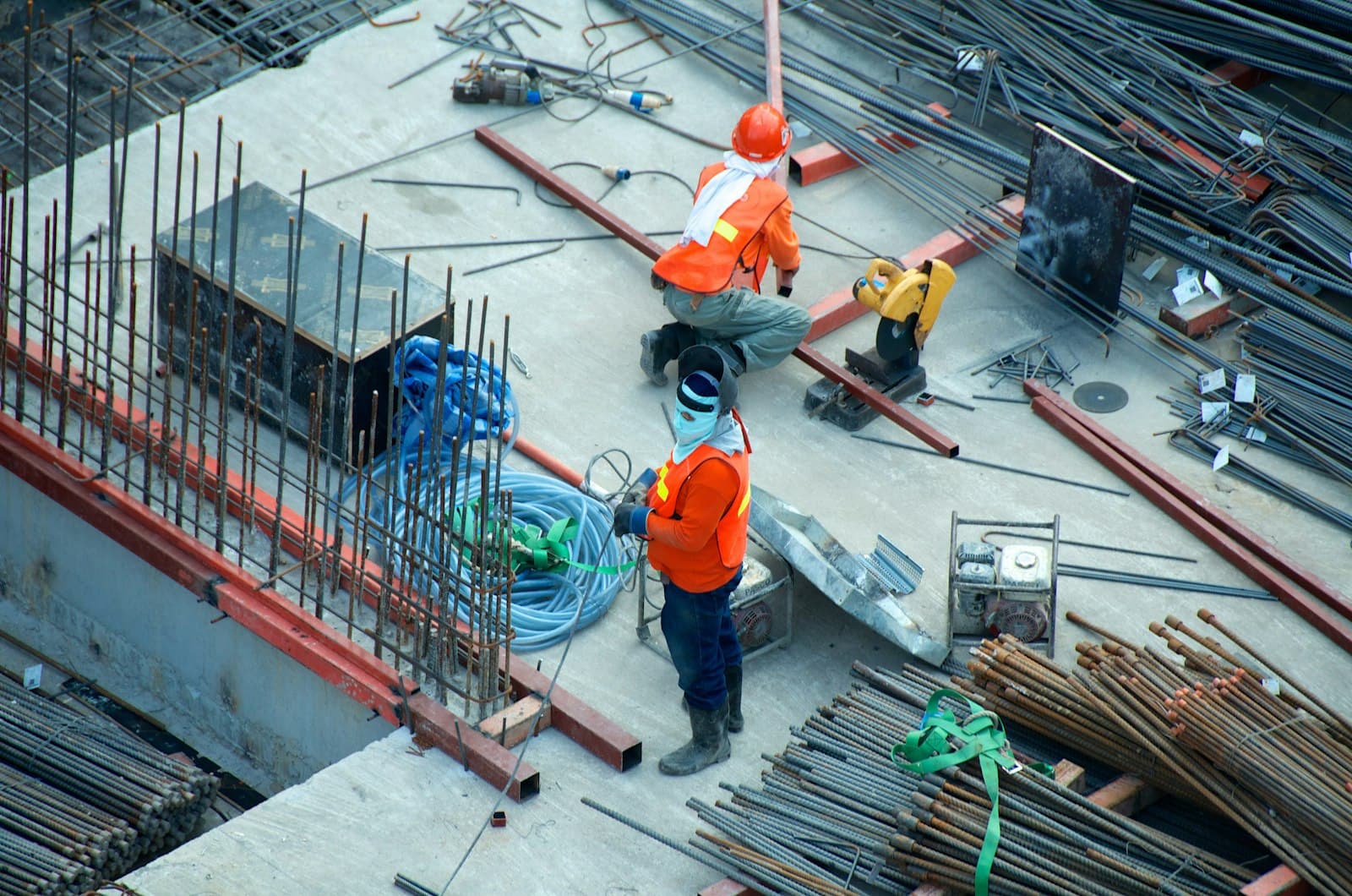Construction workers with reinforcement steel on a concrete slab