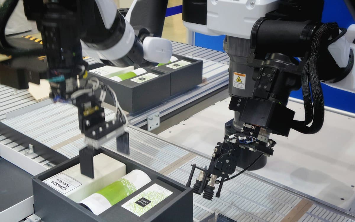 Robot arms packing products on an automated production line
