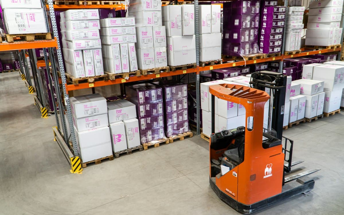 Reach truck in front of pallet racking in a distribution warehouse