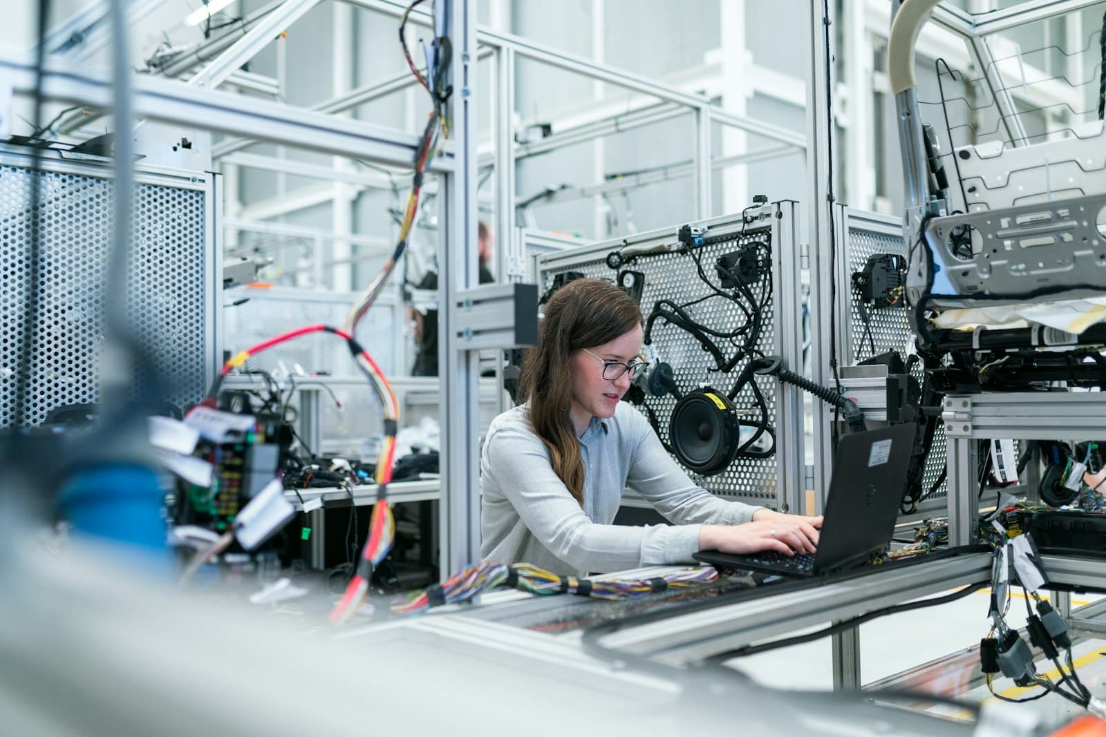 Engineer with a laptop at a test rig for cable harnesses