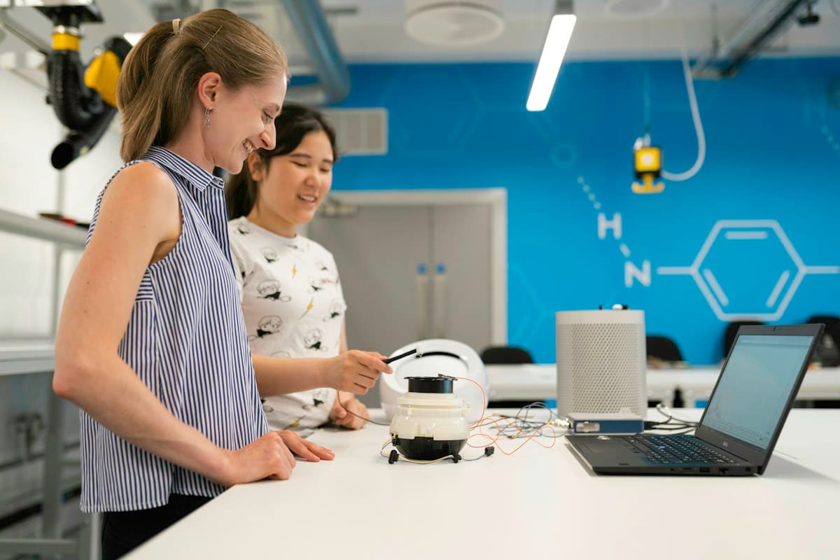Two specialists testing a device at a laboratory bench