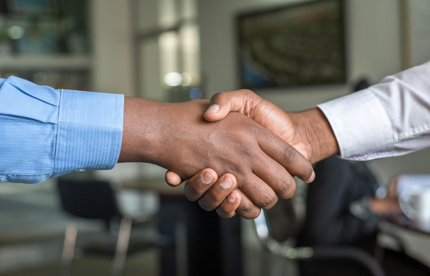 Handshake between two people in an office